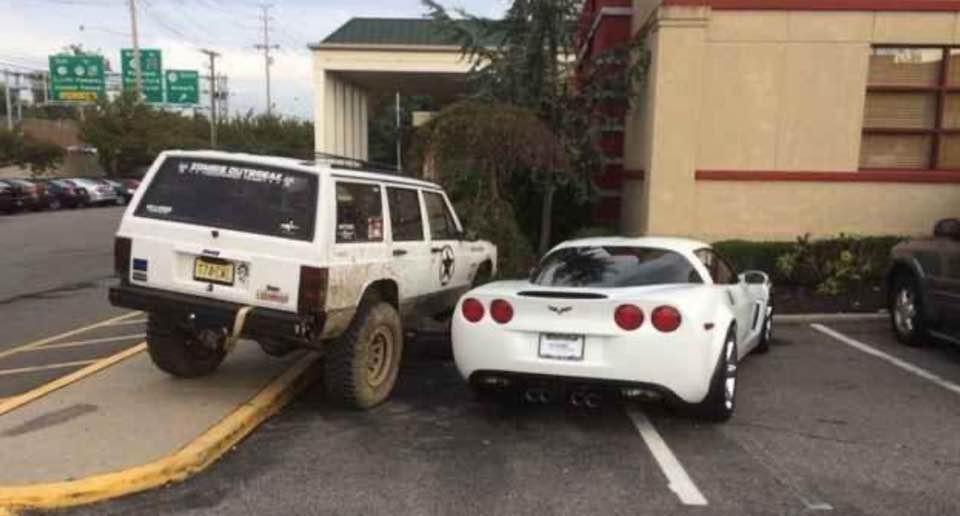 An expensive sports car purposely taking two parking spots, diagonally crossing both spots.  A law enforcement car is parked on an angle next to it in such a way that the sports car owner won't be able to open his door and will have a difficult time pulling out.